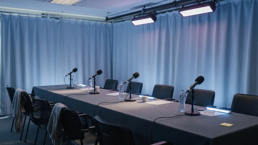 Press room chairs facing a small stage